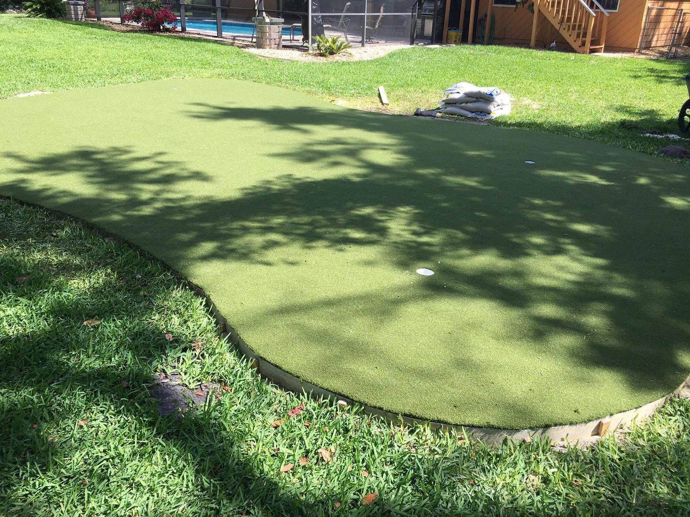 Putting green artificial turf installed in a backyard
