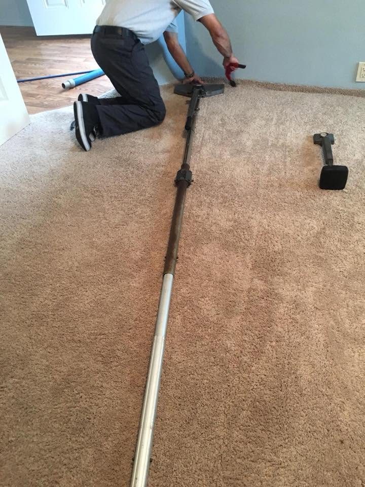 Power stretcher re-tensioning a hallway carpet