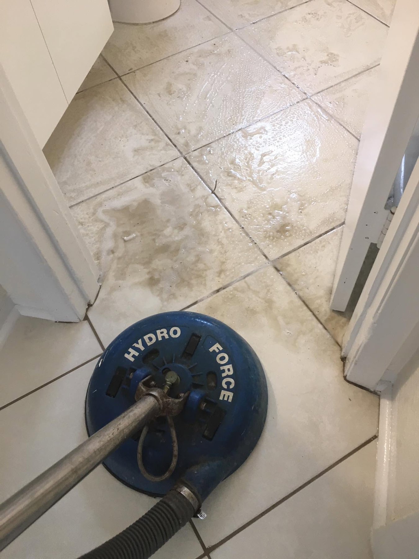 Bathroom tile and grout deep cleaned with a rotary extraction tool